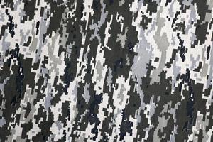 tyg med textur av ukrainska militär pixeled kamouflage. trasa med camo mönster i grå, brun och grön pixel former. officiell enhetlig av ukrainska soldater foto