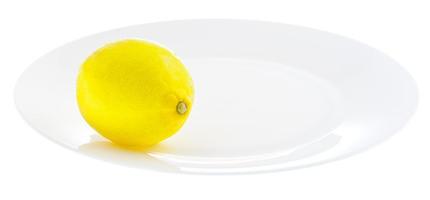 ljus gul citron- på vit tallrik foto