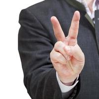 affärsman visar seger tecken - hand gestur foto