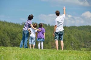 Lycklig ung familj ha roligt utomhus foto