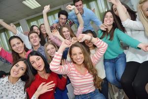 Lycklig tonåren grupp i skola foto