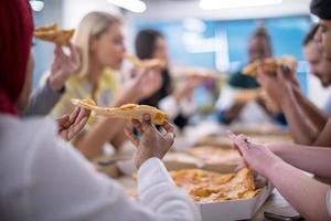 multietnisk företag team äter pizza foto