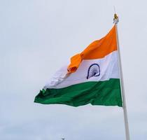 Indien flagga vajar högt på connaught plats med stolthet över blå himmel, Indien flagga vajar, indiska flaggan på självständighetsdagen och republikens dag i Indien, tilt up shot, viftande indiska flaggan, har ghar tiranga foto