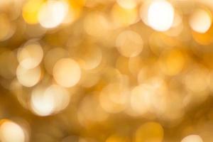 guld abstrakt bakgrund med bokeh defocused lampor foto