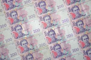 en närbild av en mönster av många ukrainska valuta sedlar med en par värde av 200 hryvnia. bakgrund bild på företag i ukraina foto