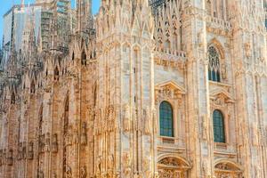 berömda kyrkan milano katedral duomo di milano med gotiska spiror och vita marmorstatyer. topp turistattraktion på piazza i milano lombardia, Italien. vidvinkelvy av gammal gotisk arkitektur och konst foto