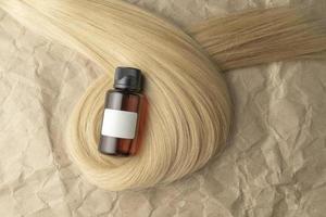 en hår behandling grundläggande olja för glättning hår liggande på en strå av blond hår foto