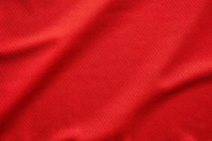röd sporter Kläder tyg fotboll jersey textur stänga upp foto