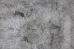 putsade grå betong vägg yta som en sömlös textur och full ram bakgrund foto