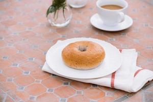 kopp av kaffe med bröd på tabell i de morgon- med solljus, frukost foto