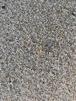 detta är en bild av en bakgrund av sand på de strand den där har bara varit tvättades bort förbi de vågor foto