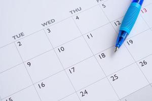 blå penna på kalender sida bakgrund företag planera utnämning möte begrepp foto