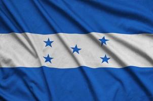 honduras flagga är avbildad på en sporter trasa tyg med många veck. sport team baner foto