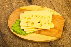 skivad ost på trä- styrelse och trä- bakgrund foto