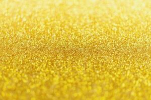 abstrakt guld glitter gnistra med bokeh ljus bakgrund foto