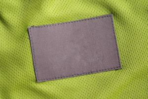 tvätt vård Kläder märka lappa på polyester tyg jersey sport textur foto