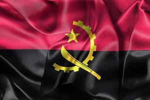 angola flagga - realistiskt viftande tygflagga foto