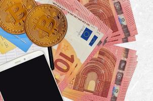 10 euro räkningar och gyllene bitcoins med smartphone och kreditera kort. kryptovaluta investering begrepp. crypto brytning eller handel foto