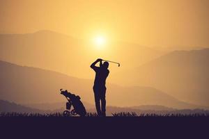 silhuett av golfare träffa sotning och ha kvar golf kurs i de sommar för koppla av tid.årgång Färg foto