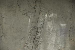 knäckt cement. betong vägg utan behandling. yta detaljer i sprickor. foto