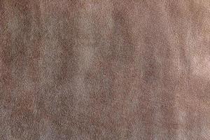 läder bakgrund. beige textur av läder, brun mocka. foto