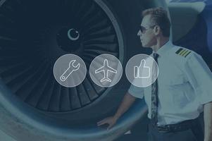 förtroende på säkerhet. digitalt sammansatt ikon uppsättning över en bild av flygplan pilot stående nära jet turbin foto