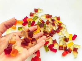 ljus, gott, ovanlig gummies tillverkad från gelatin av olika former. aptitlig sötsaker på hand. flicka framställning efterrätt för en fest. färgad gummies från nektar och juicer foto