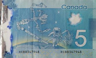 dextre och canadarm2 på kanada 5 dollar 2013 polymer sedel fragment foto