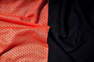 sport Kläder tyg textur bakgrund. topp se av röd polyester nylon- trasa textil- yta. färgad basketboll skjorta med fri Plats för text foto