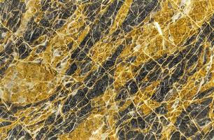 gyllene marmor textur med många kontrasterande texturer. foto