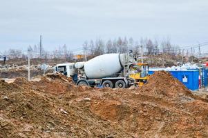 stor kraftfull lastbil betong mixer på ett industriell stor konstruktion webbplats foto