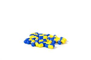 grupp av gula och blåa piller foto