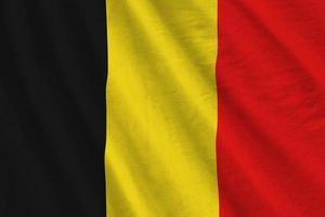 belgien flagga med stor veck vinka stänga upp under de studio ljus inomhus. de officiell symboler och färger i baner foto