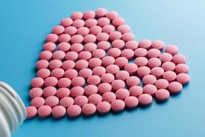 rosa b12 piller i de form av en hjärta på en blå bakgrund, hällde ut av en vit kan foto