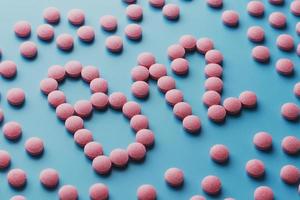 rosa tabletter i de form av b12 närbild på en blå bakgrund, låg kontrast foto