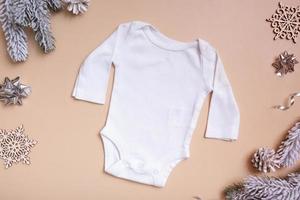 bebis bebis Kläder attrapp för logotyp, text eller design på beige bakgrund med vinter- dekorationer topp se foto