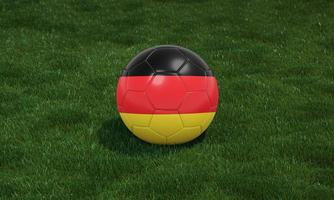 fotboll boll med Tyskland flagga färger på en stadion på grön gräs bakgrund. foto