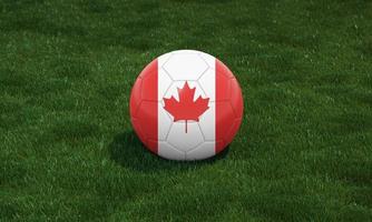 fotboll boll med kanada flagga färger på en stadion på grön gräs bakgrund. foto