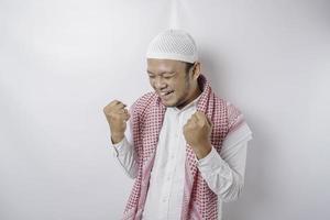 en ung asiatisk muslim man med en Lycklig framgångsrik uttryck isolerat förbi vit bakgrund foto