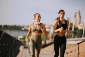 ung kvinna som tar springövning vid flodpromenaden foto