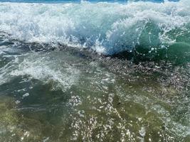 vågor, stänk av vatten på de strand på de hav på semester i en turist värma östra tropisk Land sydlig paradis tillflykt på semester. de bakgrund foto