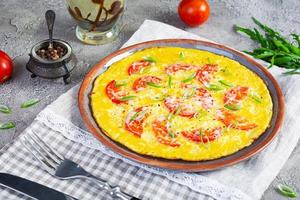 omelett med tomater, örter och riven ost. lätt frukost foto