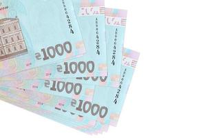 1000 ukrainska hryvnias räkningar lögner i små knippa eller packa isolerat på vit. attrapp med kopia Plats. företag och valuta utbyta foto