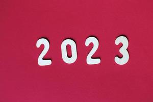 inskrift 2023 med trä- tal på röd bakgrund .festlig begrepp foto