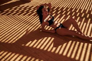 skön ung kvinna i bikini ha semester på de hav på solig dagtid foto