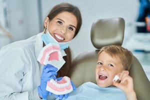 liten pojke och kvinna tandläkare i de tandläkare kontor foto