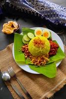 nasi kuning eller gul ris eller tumör ris är traditionell mat från Asien, tillverkad ris kokta med gurkmeja, kokos mjölk r foto