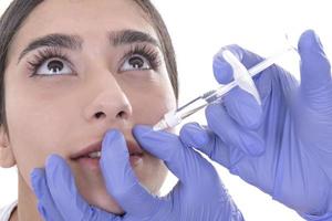 ung kvinna får injektion av botox. anti-åldring injektion foto