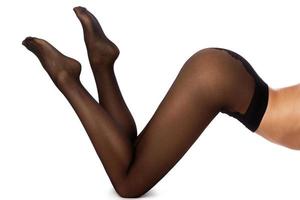 kvinna ben i svart strumpbyxor foto