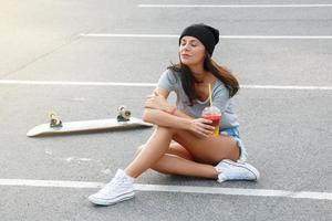 porträtt av skön flicka med en skateboard foto